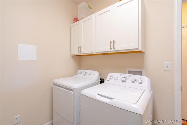 washroom with cabinet space and separate washer and dryer
