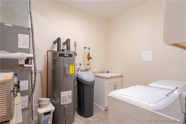 laundry room featuring washing machine and dryer, water heater, cabinet space, and light tile patterned floors
