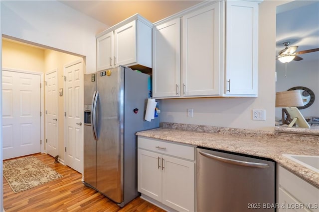 kitchen featuring appliances with stainless steel finishes, white cabinets, light wood finished floors, and a ceiling fan