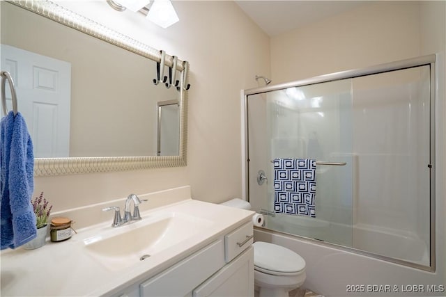 full bath featuring toilet, vanity, and shower / bath combination with glass door