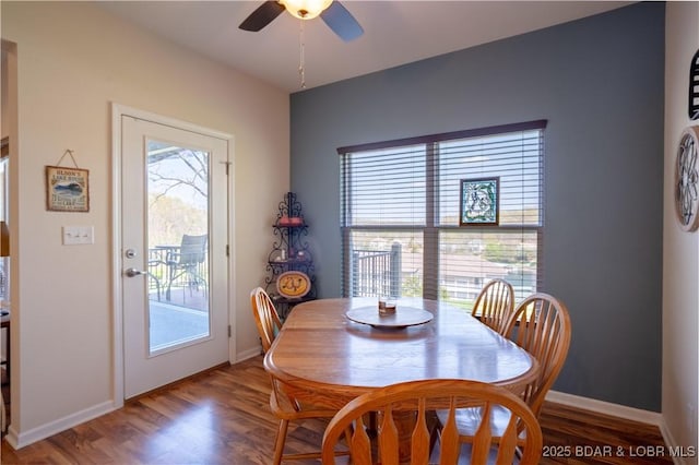 dining space with ceiling fan, wood finished floors, and baseboards