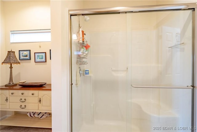 bathroom featuring a stall shower and vanity