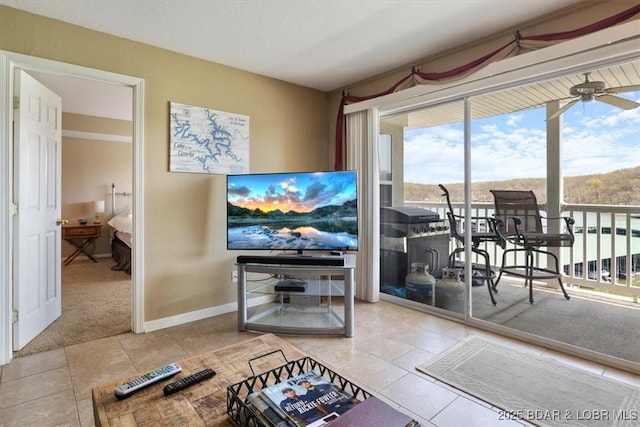 4800 Eagleview Dr Unit 133, Osage Beach, MO 65065 - living area featuring tile patterned floors, ceiling fan, baseboards, and carpet floors