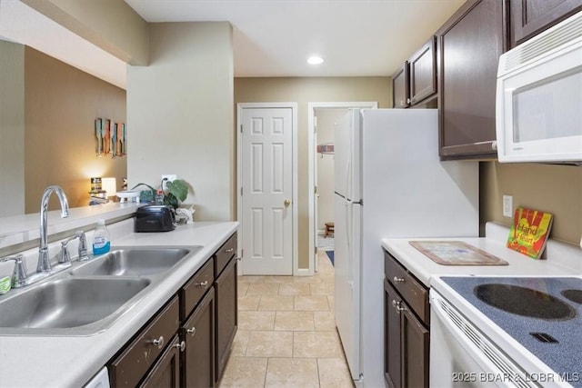 4800 Eagleview Dr Unit 133, Osage Beach, MO 65065 - kitchen featuring white appliances, a sink, dark brown cabinets, light countertops, and recessed lighting
