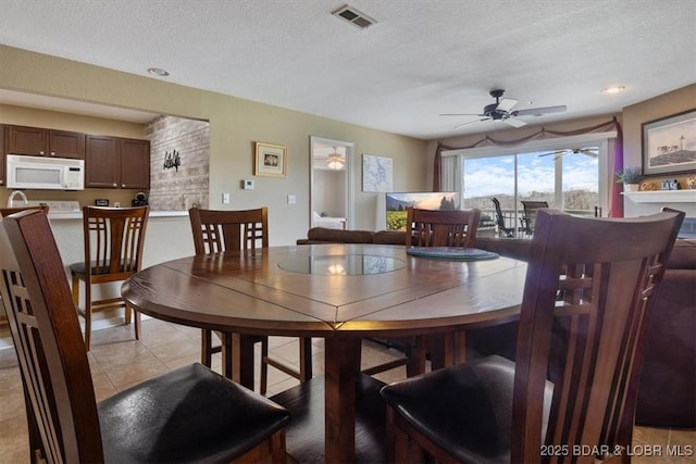 4800 Eagleview Dr Unit 133, Osage Beach, MO 65065 - dining room featuring ceiling fan, a textured ceiling, and light tile patterned floors