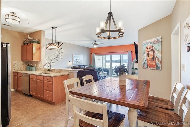 dining area featuring light tile patterned floors, visible vents, and ceiling fan with notable chandelier