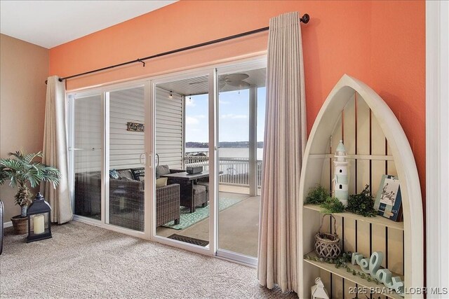 doorway to outside featuring carpet and a water view