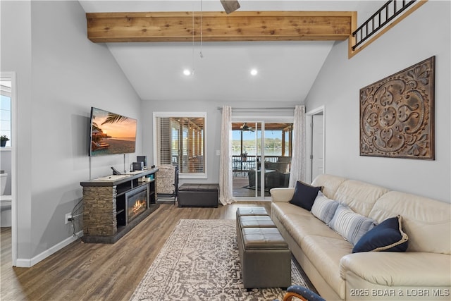 living room with vaulted ceiling with beams, baseboards, recessed lighting, wood finished floors, and a fireplace