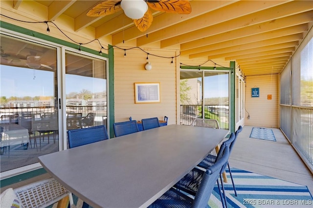 245 Bristol Bay Dr Unit 2B, Lake Ozark, MO 65049 - dining area featuring plenty of natural light, wooden walls, and a ceiling fan