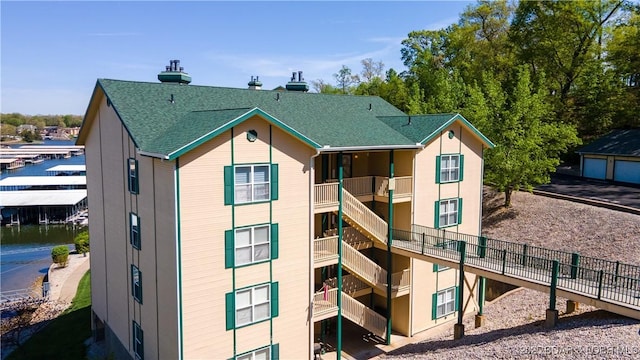245 Bristol Bay Dr Unit 2B, Lake Ozark, MO 65049 - rear view of house with roof with shingles and stairway