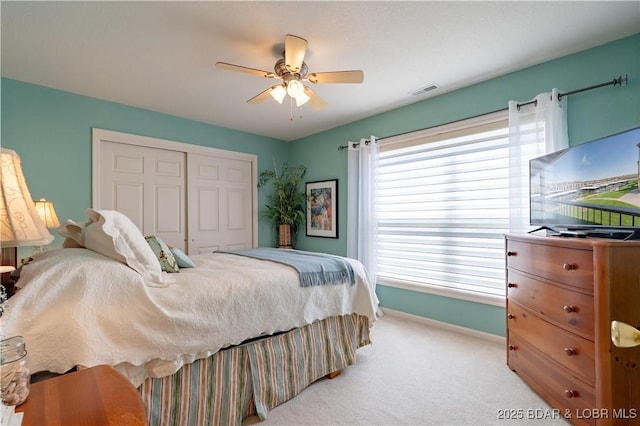 245 Bristol Bay Dr Unit 2B, Lake Ozark, MO 65049 - bedroom featuring a closet, light colored carpet, baseboards, and ceiling fan