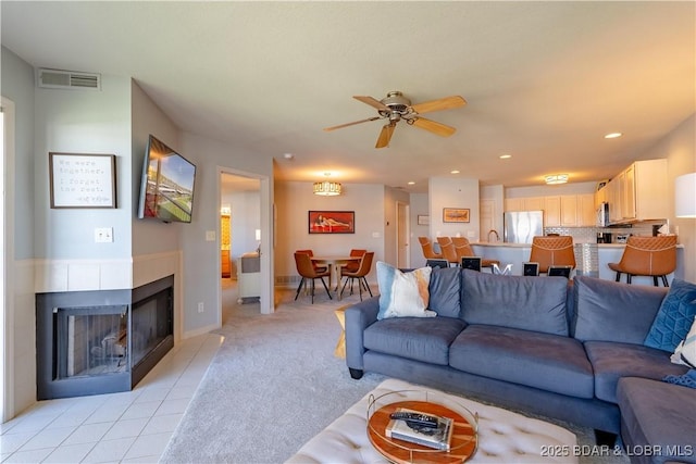 245 Bristol Bay Dr Unit 2B, Lake Ozark, MO 65049 - living area with a ceiling fan, a multi sided fireplace, light colored carpet, recessed lighting, and baseboards