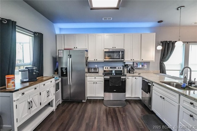 284 Bloomington Dr, Lake Ozark, MO 65049 - kitchen with stainless steel appliances, dark wood-style flooring, white cabinets, and light stone counters