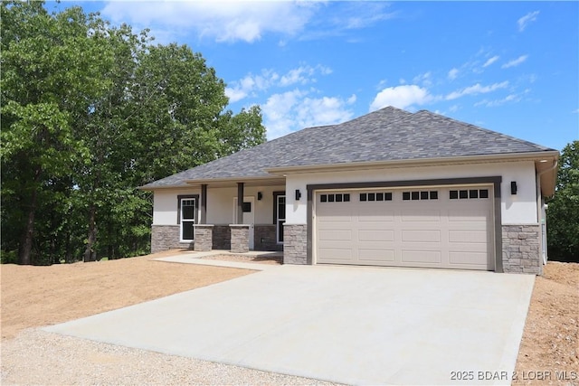 25 Sam Dr, Kaiser, MO 65047 - view of front of property with stone siding, driveway, a garage, and stucco siding