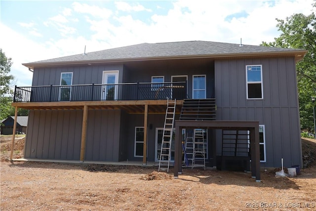 25 Sam Dr, Kaiser, MO 65047 - rear view of house featuring a wooden deck and a shingled roof