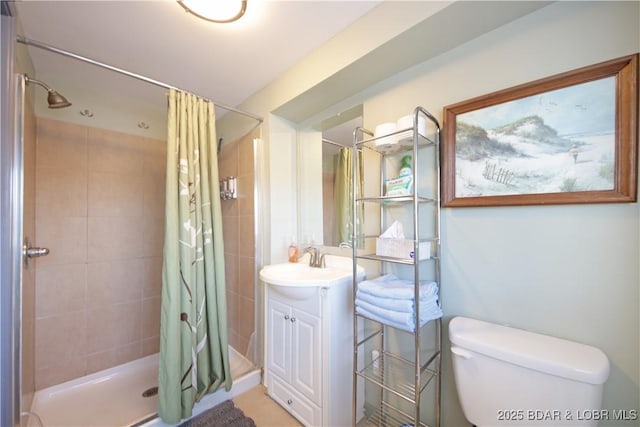 full bathroom featuring toilet, vanity, and a stall shower