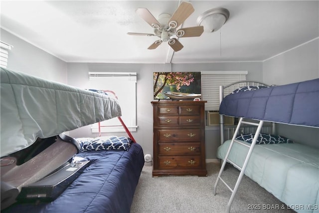 bedroom featuring a ceiling fan, carpet flooring, and multiple windows