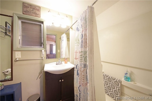 bathroom with curtained shower and vanity