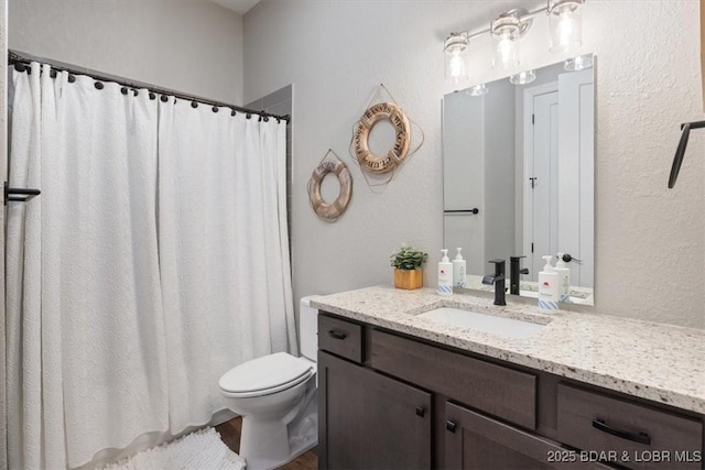 1065 Topsider Ln Unit 508, Osage Beach, MO 65065 - bathroom featuring curtained shower, a textured wall, toilet, and vanity