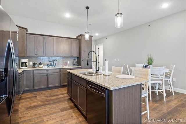 1065 Topsider Ln Unit 508, Osage Beach, MO 65065 - kitchen with a sink, appliances with stainless steel finishes, a kitchen bar, backsplash, and dark wood-style flooring