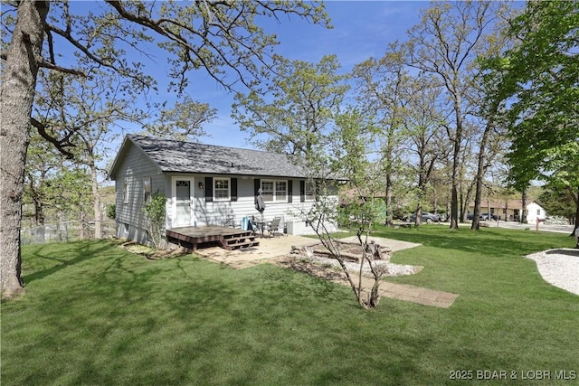 back of property featuring a yard and a deck