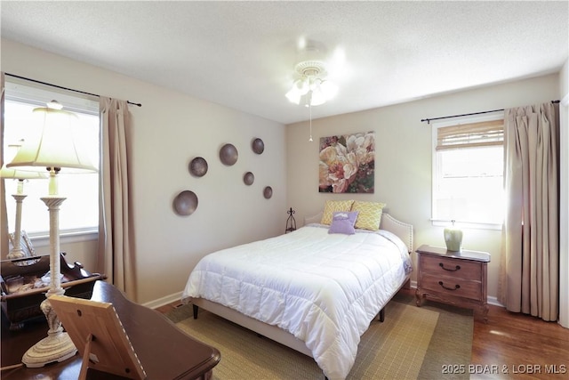 bedroom featuring baseboards and wood finished floors