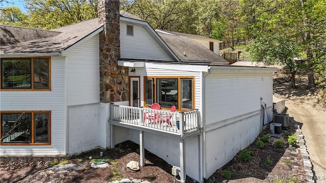 342 Porter Mill Springs Dr, Sunrise Beach, MO 65079 - rear view of property with a shingled roof and a chimney