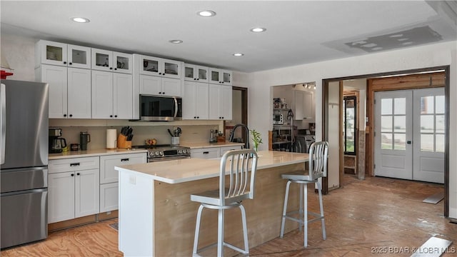 342 Porter Mill Springs Dr, Sunrise Beach, MO 65079 - kitchen featuring recessed lighting, light countertops, an island with sink, and stainless steel appliances
