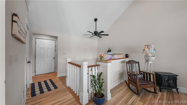 342 Porter Mill Springs Dr, Sunrise Beach, MO 65079 - hallway with an upstairs landing, baseboards, wood finished floors, and high vaulted ceiling