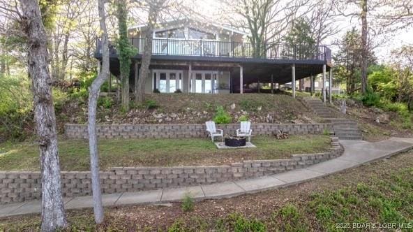 30 Lockwood Rd, Eldon, MO 65026 - rear view of property featuring a wooden deck, stairway, and an outdoor fire pit