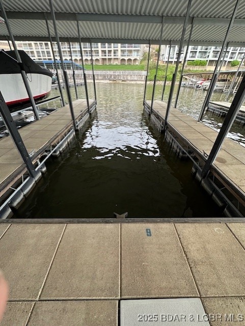 view of dock with boat lift and a water view