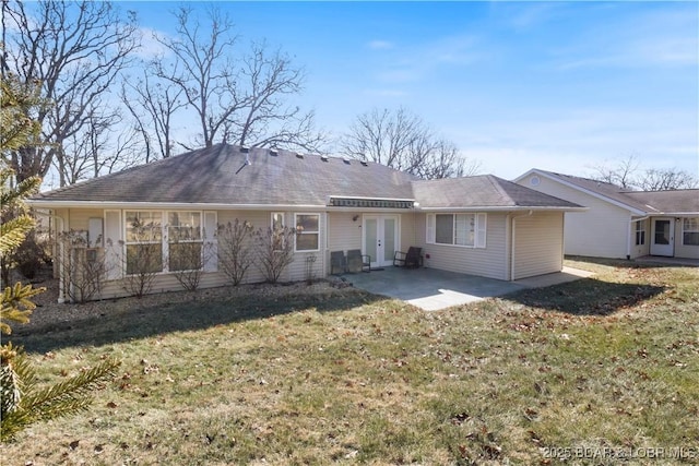 back of house featuring a patio, french doors, and a lawn