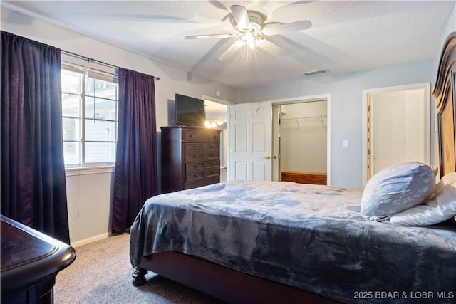 bedroom with a closet, carpet floors, visible vents, baseboards, and ceiling fan