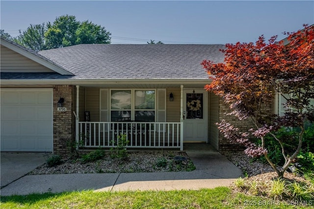 3796 Meadow Ln, Osage Beach, MO 65065 - view of front of home featuring covered porch, a garage, and roof with shingles