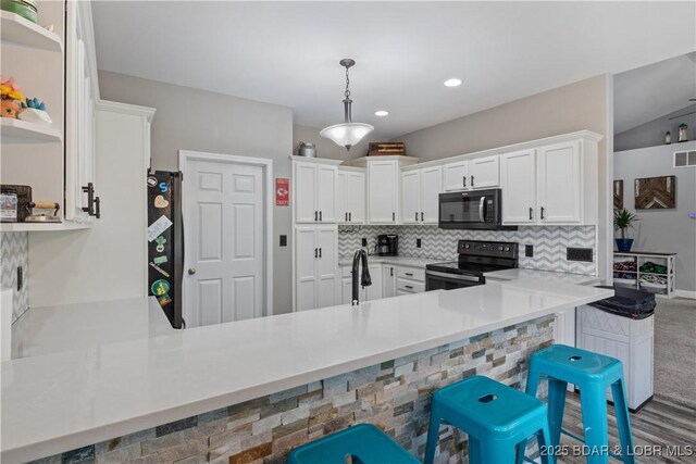 kitchen with decorative backsplash, open shelves, black appliances, a peninsula, and white cabinetry