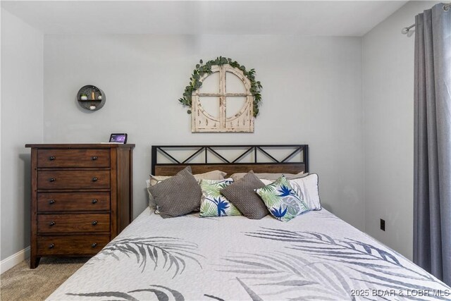 carpeted bedroom featuring baseboards