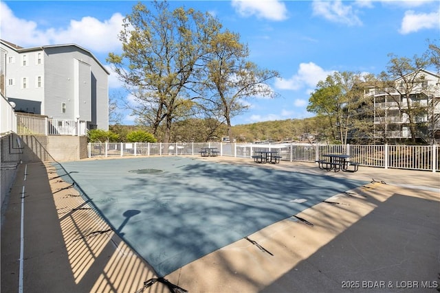 view of pool featuring fence