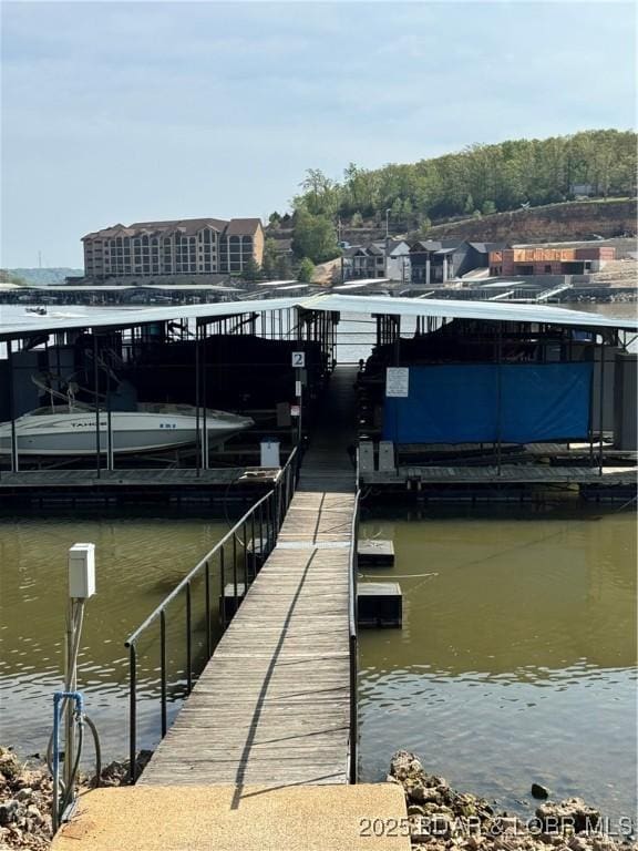 view of dock featuring a water view and boat lift