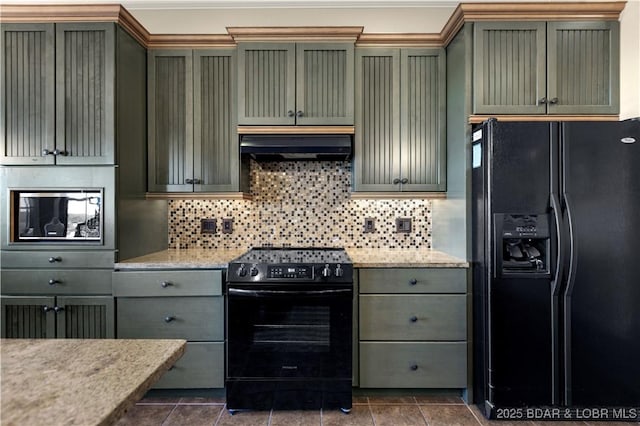 kitchen with black appliances, green cabinets, backsplash, and under cabinet range hood