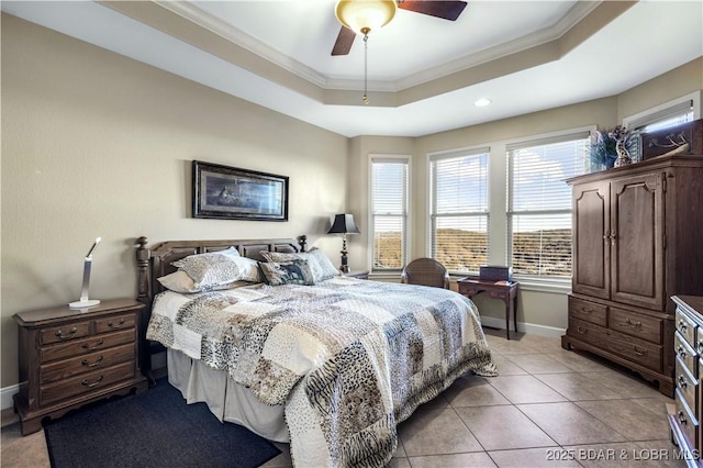 bedroom featuring ornamental molding, multiple windows, baseboards, and a tray ceiling