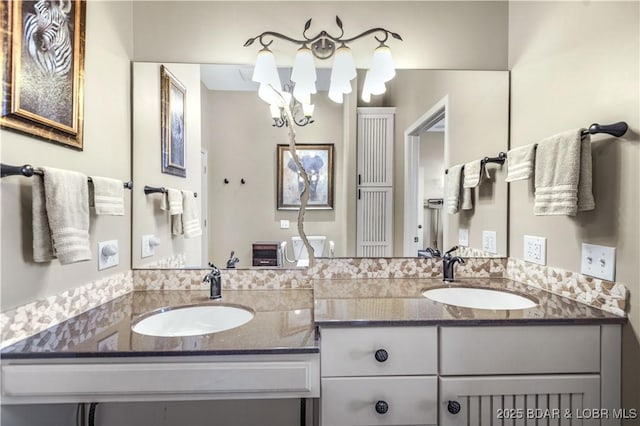 full bathroom with an inviting chandelier, double vanity, and a sink