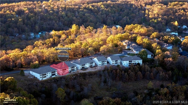 drone / aerial view featuring a wooded view