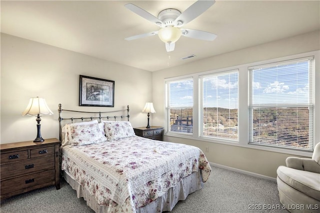bedroom with light colored carpet, visible vents, ceiling fan, and baseboards