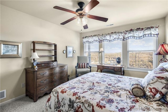 carpeted bedroom featuring visible vents, a ceiling fan, and baseboards