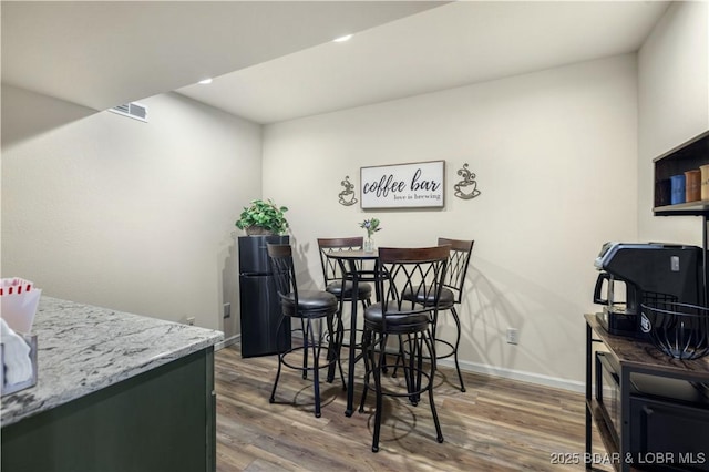 dining room featuring recessed lighting, visible vents, wood finished floors, and baseboards