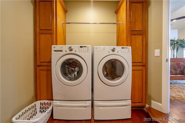 4956 Shorewood Dr, Osage Beach, MO 65065 - clothes washing area with cabinet space, baseboards, independent washer and dryer, and dark wood-style flooring