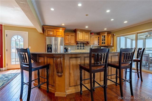 4956 Shorewood Dr, Osage Beach, MO 65065 - kitchen with a wealth of natural light, brown cabinetry, stainless steel fridge, and crown molding
