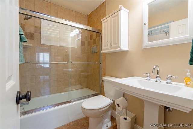 4956 Shorewood Dr, Osage Beach, MO 65065 - bathroom with tile patterned floors, combined bath / shower with glass door, and toilet