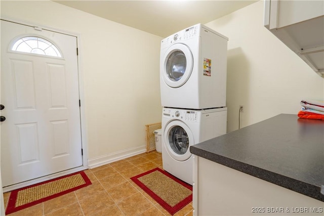4956 Shorewood Dr, Osage Beach, MO 65065 - washroom featuring baseboards, stacked washer / dryer, light tile patterned floors, and laundry area