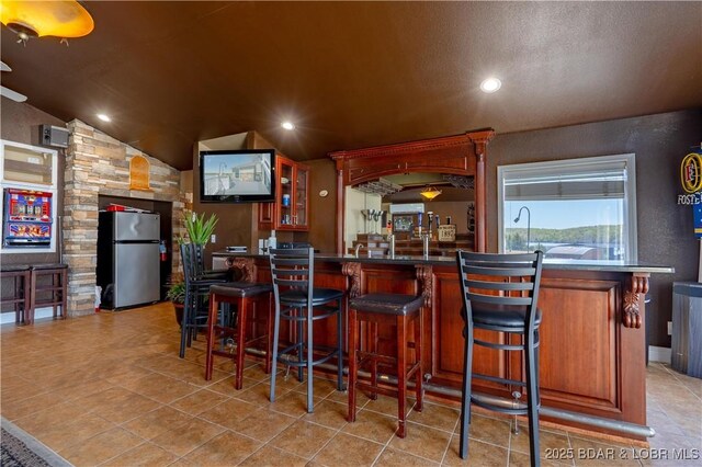4956 Shorewood Dr, Osage Beach, MO 65065 - bar featuring a community bar, light tile patterned floors, freestanding refrigerator, and recessed lighting